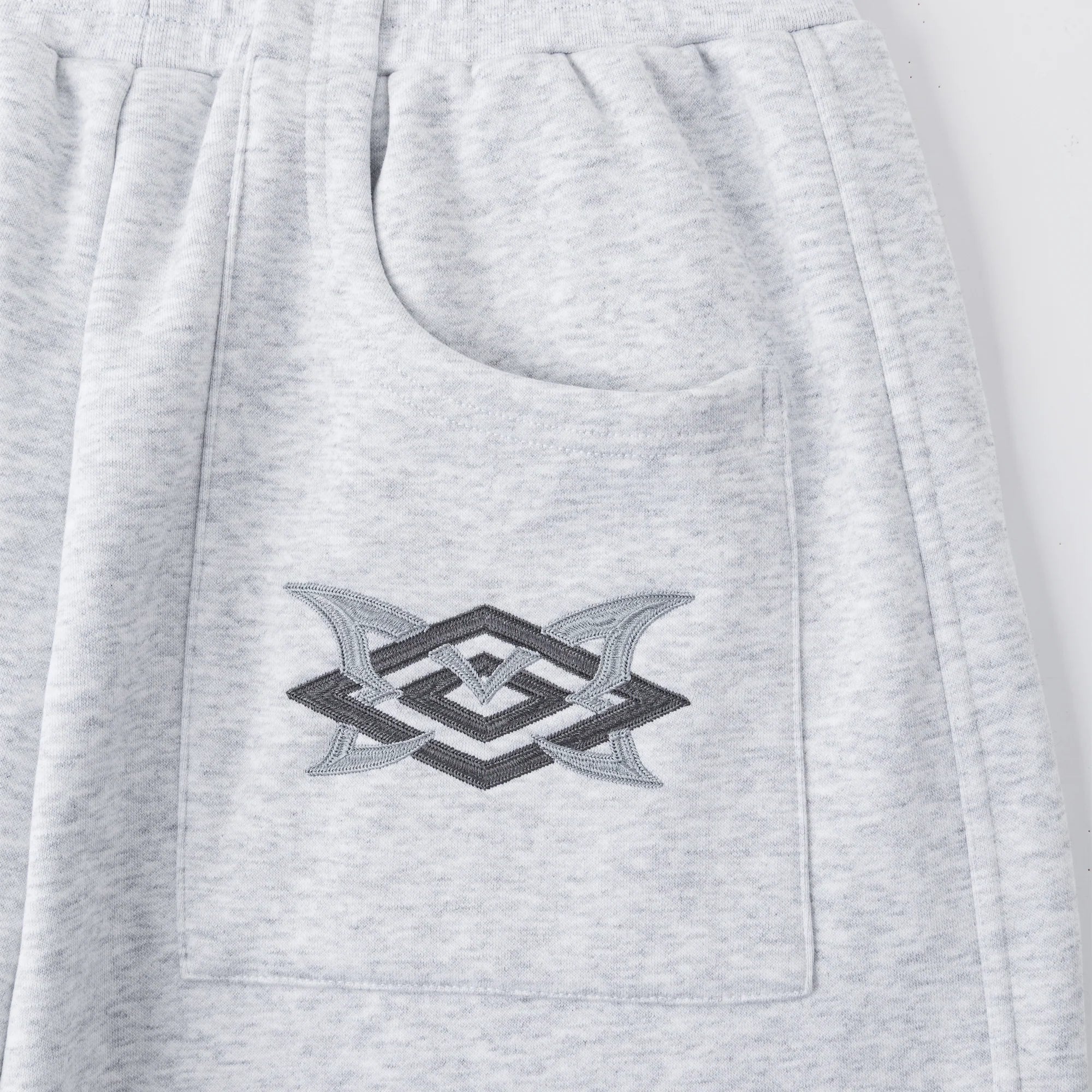 Gray sweatshirt with a geometric logo on the chest pocket